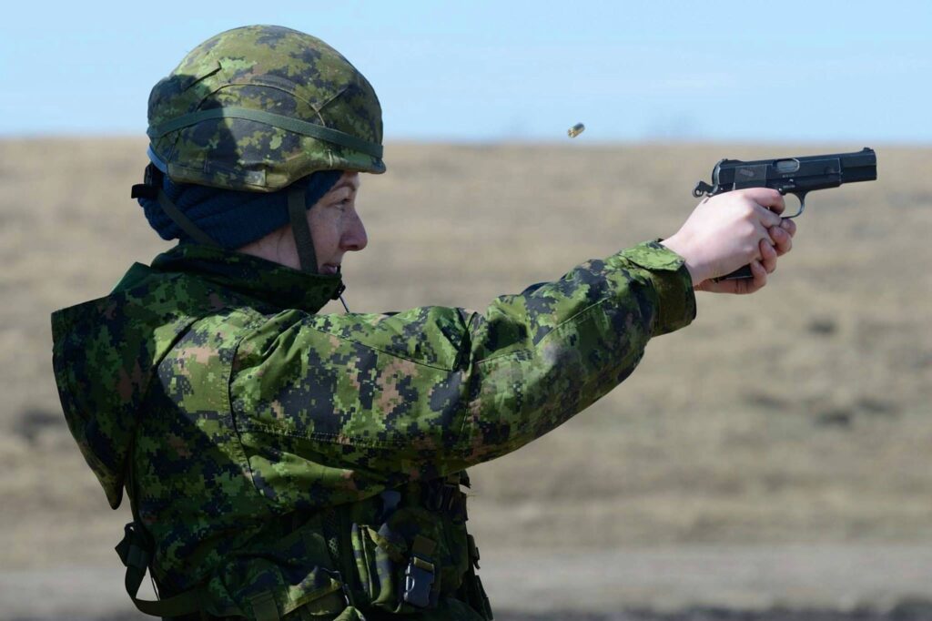 The author in military gear, shooting a rifle.